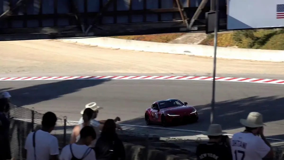 Performance car approaching a Laguna Seca corner