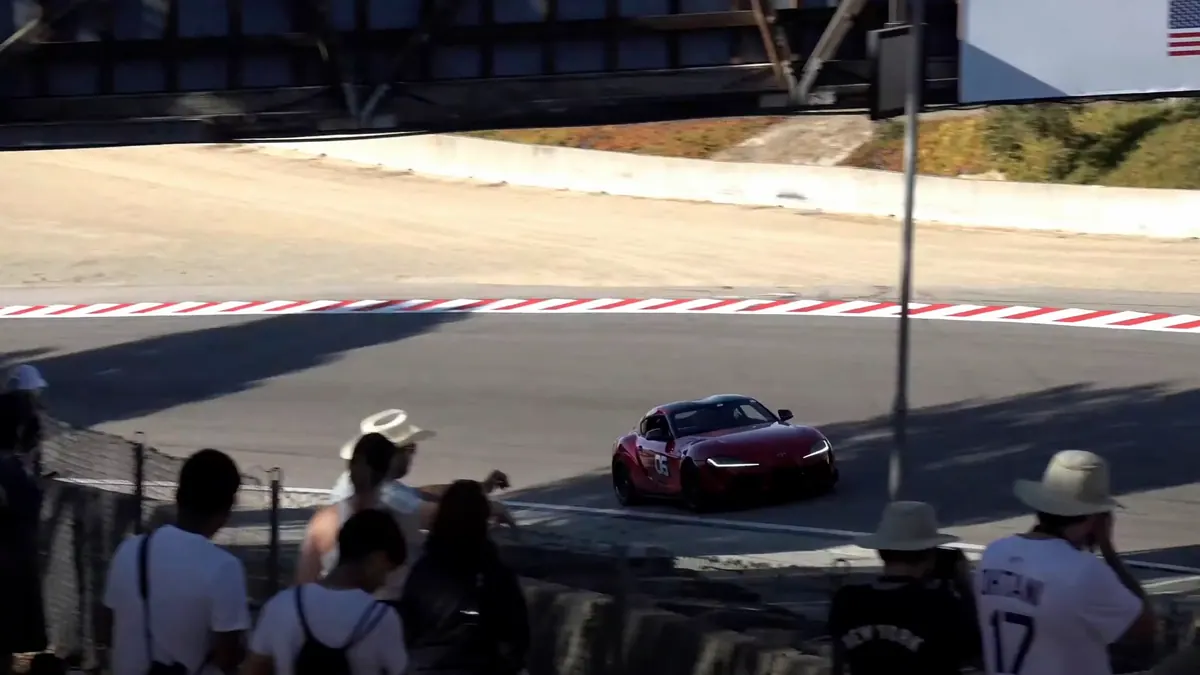 Performance car loaded through a Laguna Seca corner